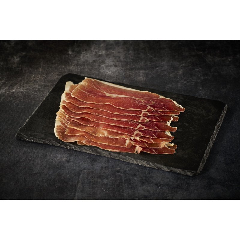 Jambon Serrano Grande Réserve tranché sur un plateau d'ardoise